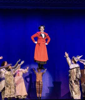 Mary Poppins floating above cast