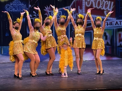 6 high school dancers posing in Bushel and a Peck costumes