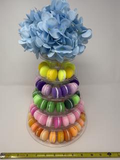 A tiered display stand holding faux macarons in bright colors