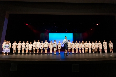 Cast is lined up for gym inspection by Ms. Trunchbull