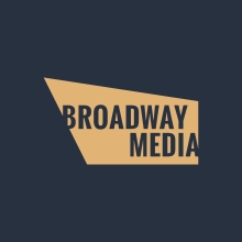 A gold spotlight with the words Broadway Media against a navy blue background.