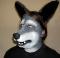 A man wearing a foam latex wolf muzzle prosthetic with makeup and ears