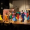 A group of students onstage dancing